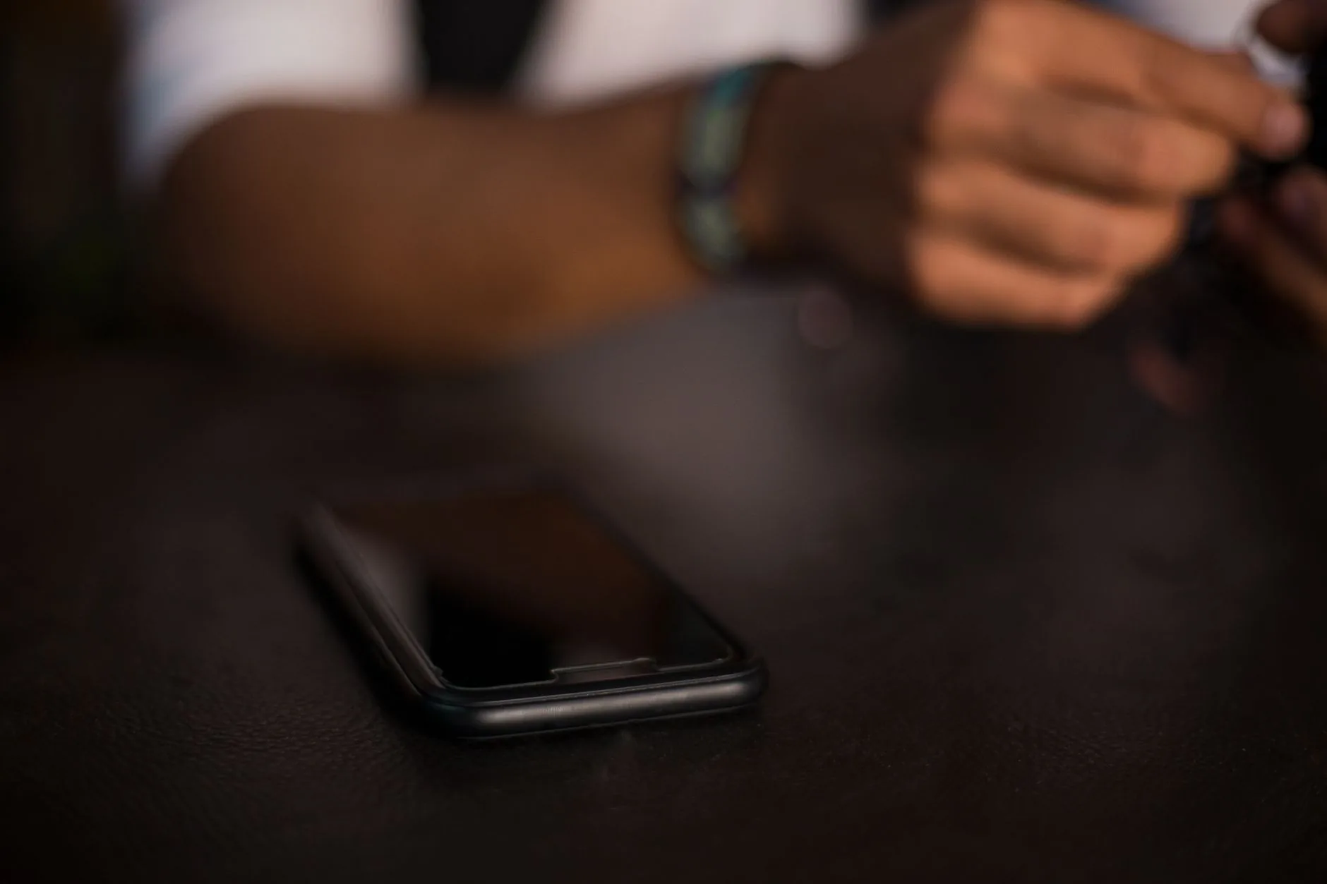 Smartphone showing 10 Minute in Spanish app, soft lighting, muted colors.